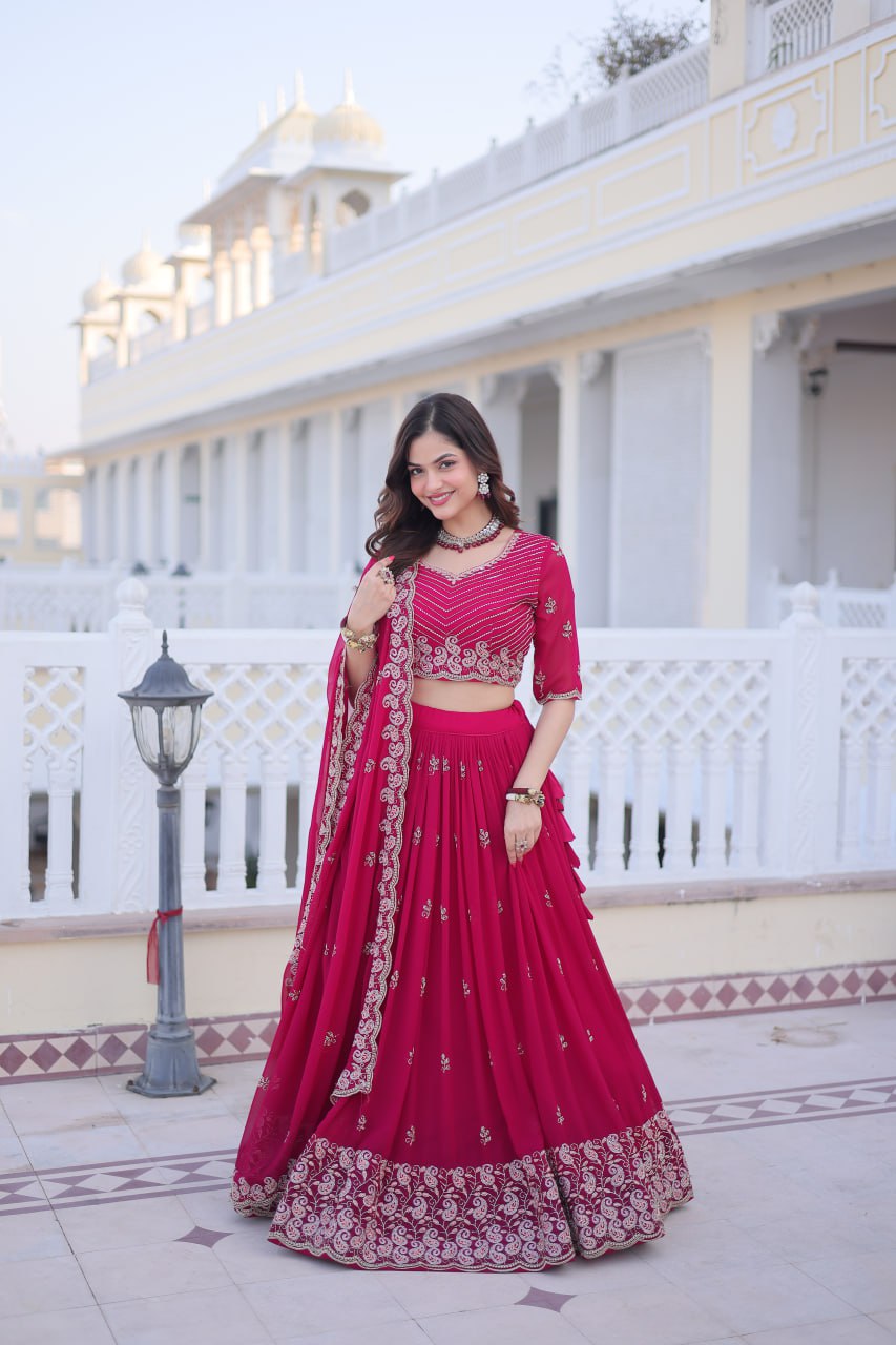 Woman in Pinl embroidered traditional outfit.