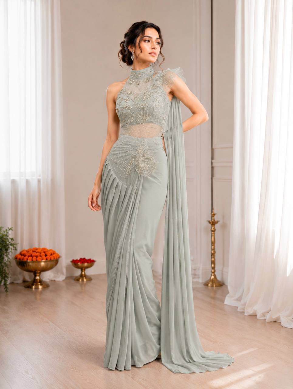 A woman models a sage green, high-neck, sleeveless saree