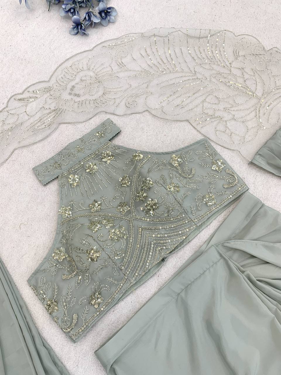 A sage green embroidered blouse and matching draped fabric